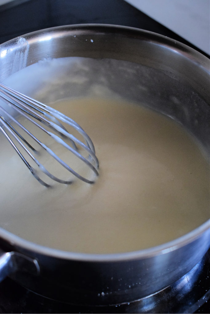 Making a roux sauce in a saucepan.