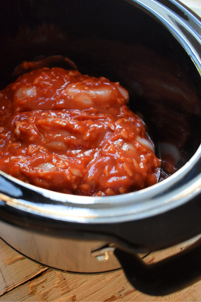 chicken and sauce in a slow cooker