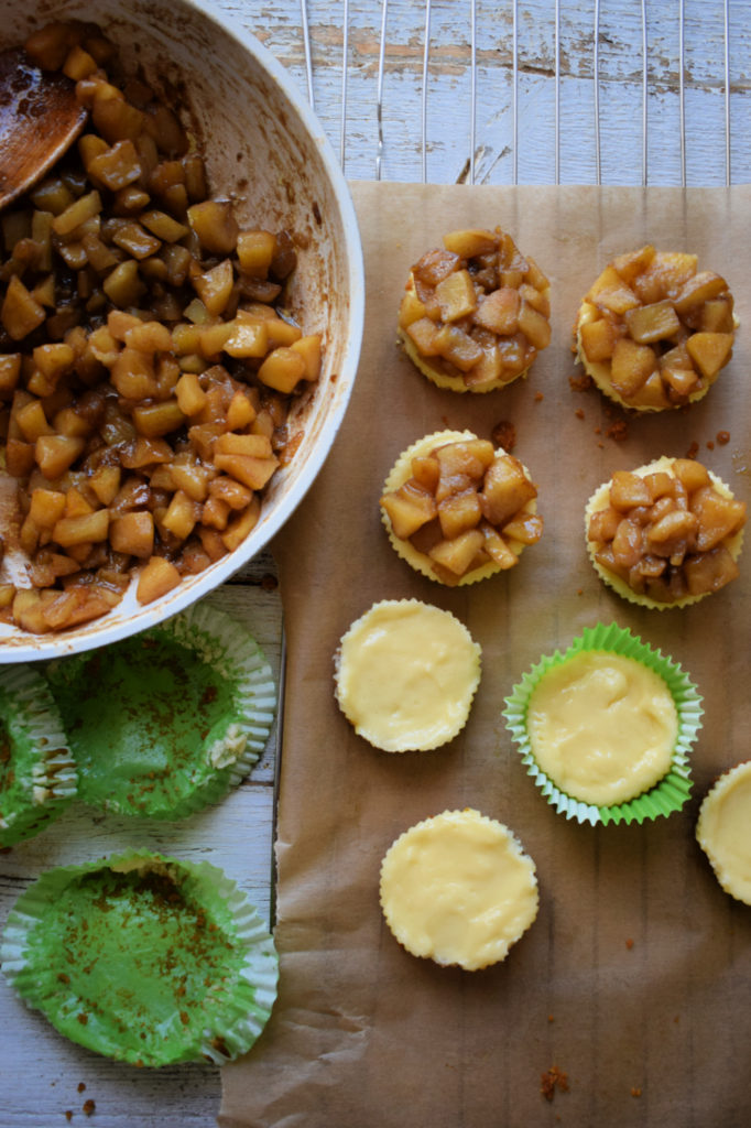 putting together mini cheesecakes on white table