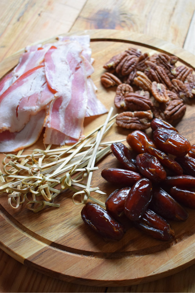 bacon, dates, pecans on a board
