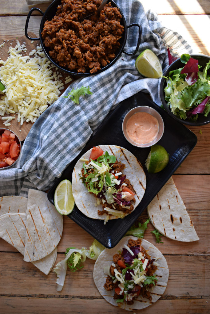 over head table setting view of  Pork tacos with sriracha mayo