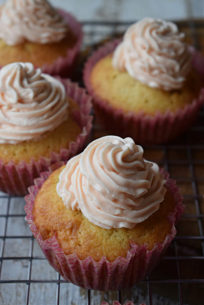 close up of a cupcake with pink frosting