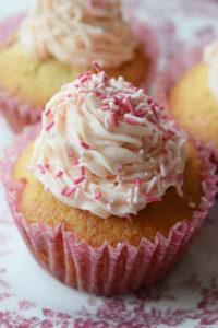 close up of strawberry cupcakes wiht buttercream frosting
