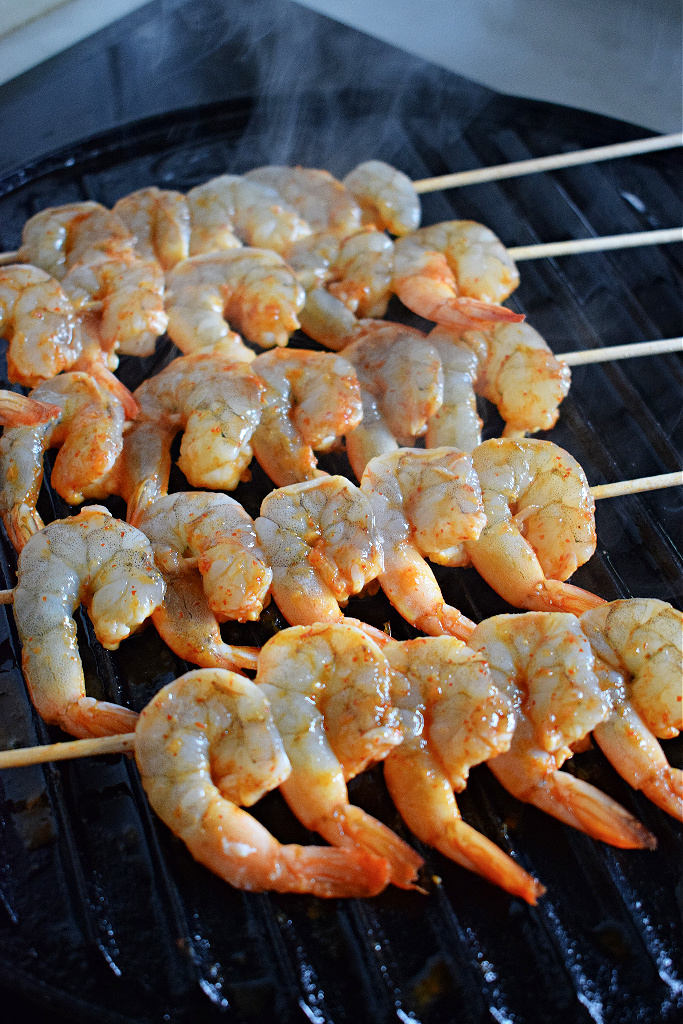 spiced honey lime shrimp grilling on the stove
