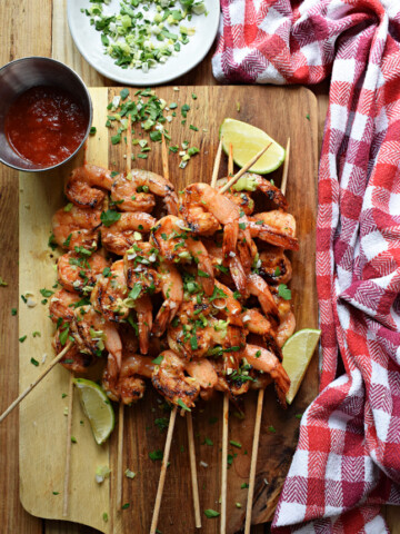 spiced honey lime shrimp on a board with dips
