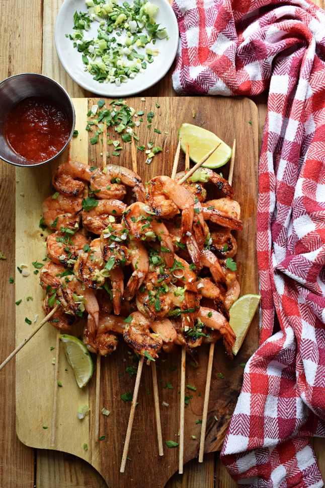 spiced honey lime shrimp on a board with dips 