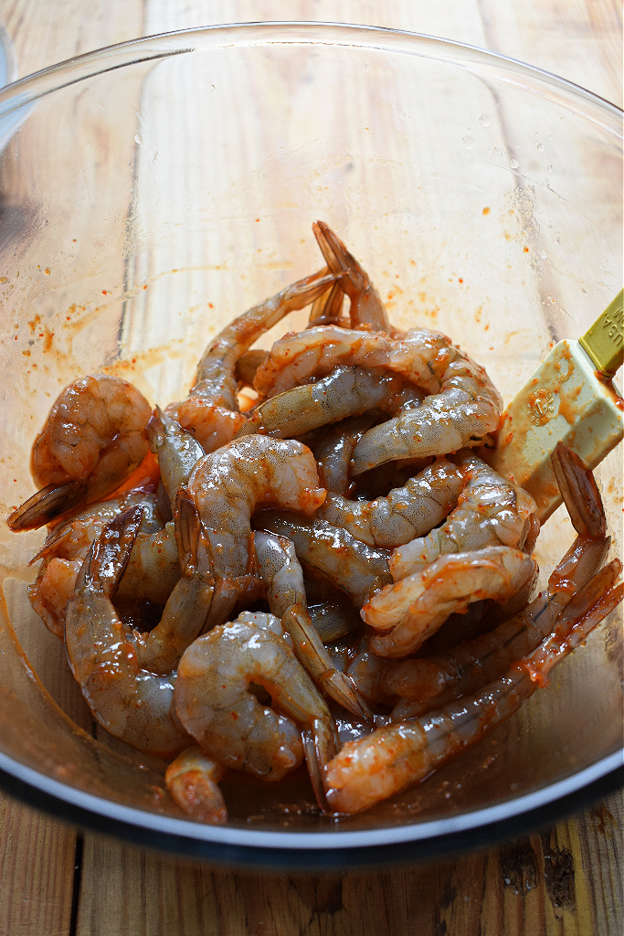 shrimp marinading in a bowl to make the spiced shirmp