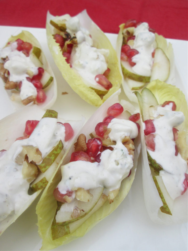 Blue Cheese and pomegranate salad cups on a white plate