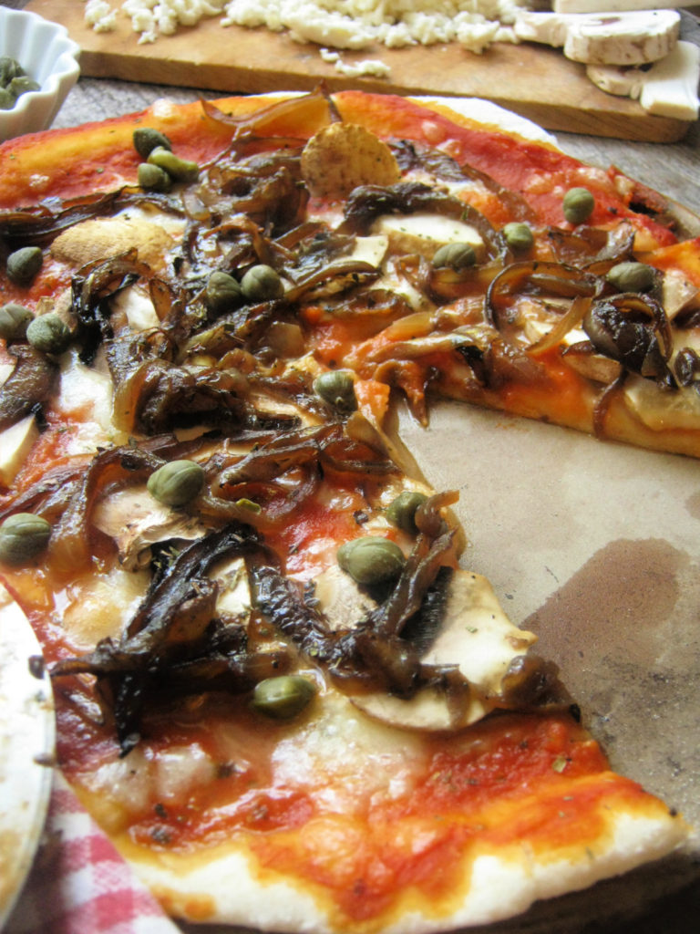 close up of the Caramelized Onion Musrhoom and Caper Pizza