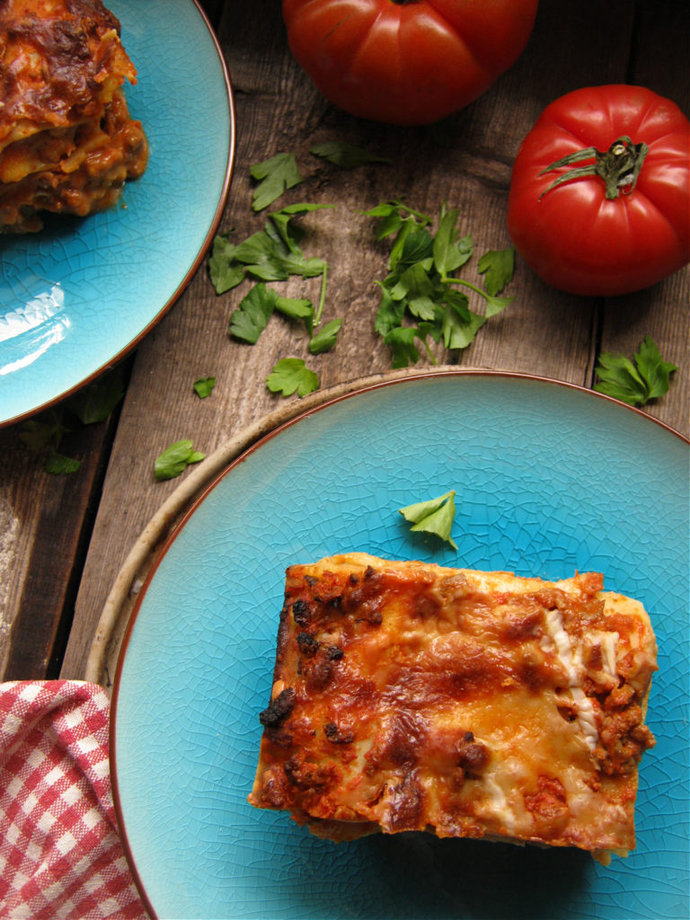 classic lasagna on blue plates