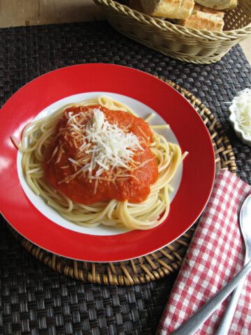 classic spaghetti with classic marinara with a fork and a napkin