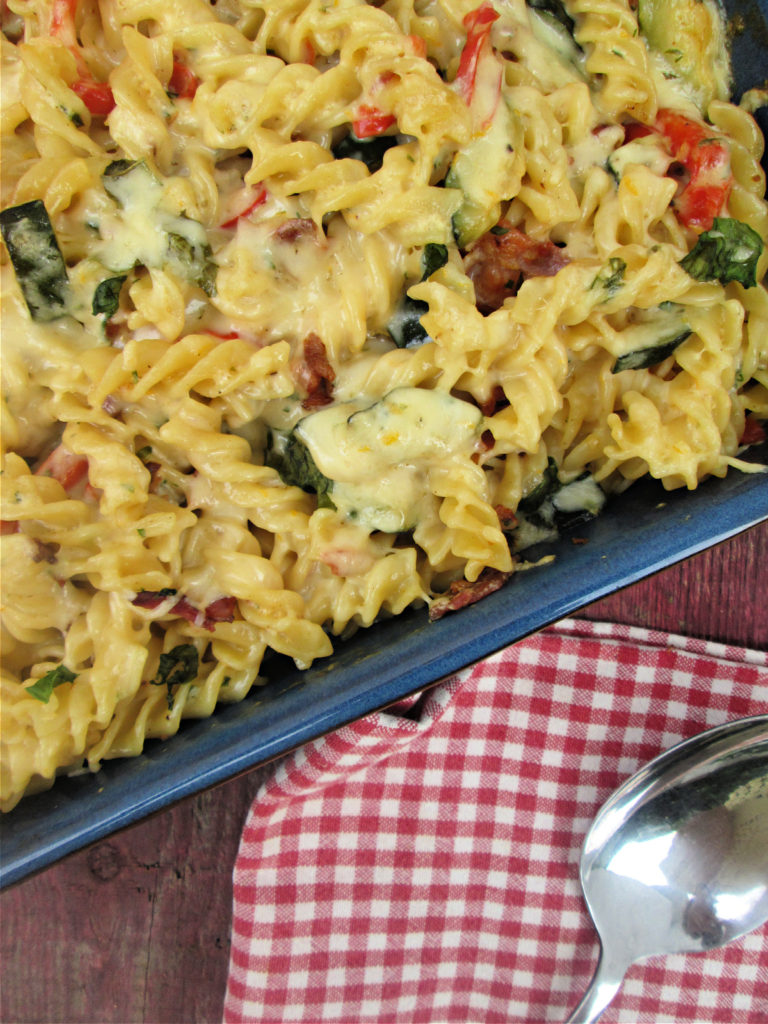 The fusilli pasta bake with bacon and zucchini in a serving dish