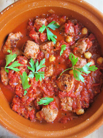Italian Sausage & Tomato Stew in a terra cotta dish