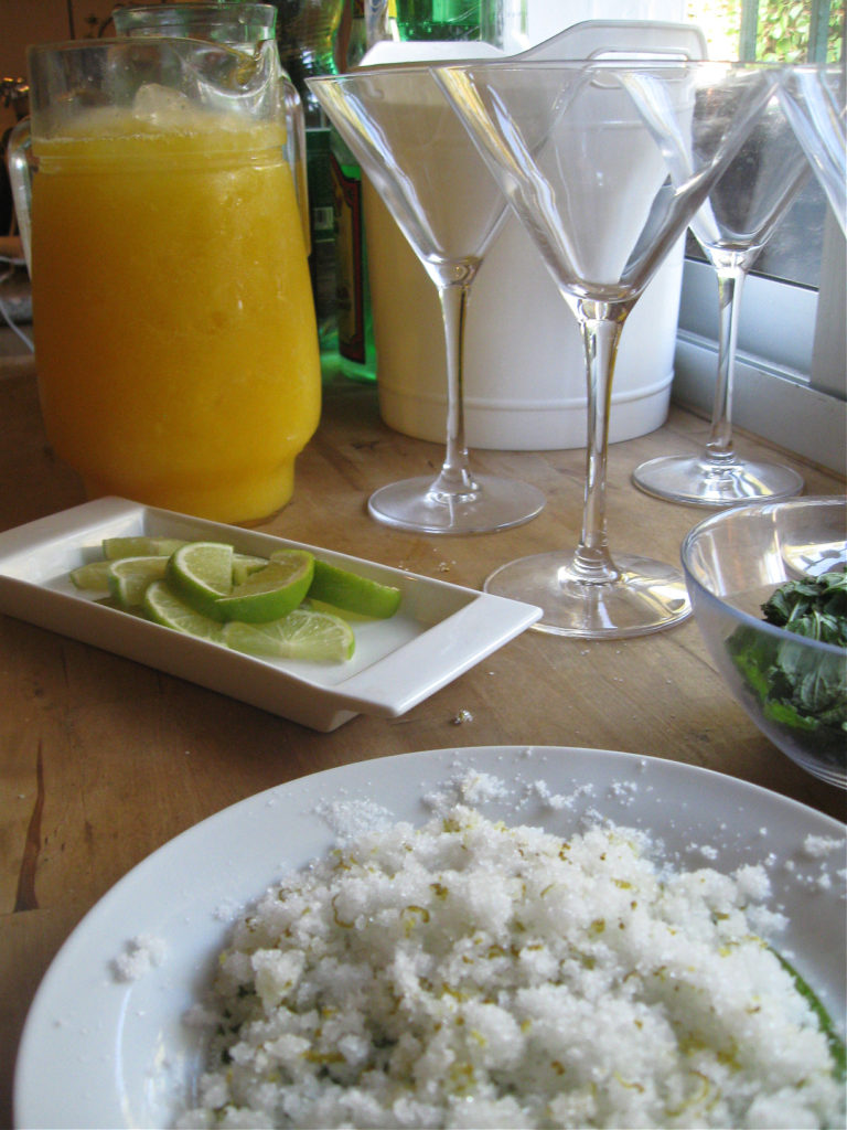 a pitcher of mango margaritas with crused ice and glasses