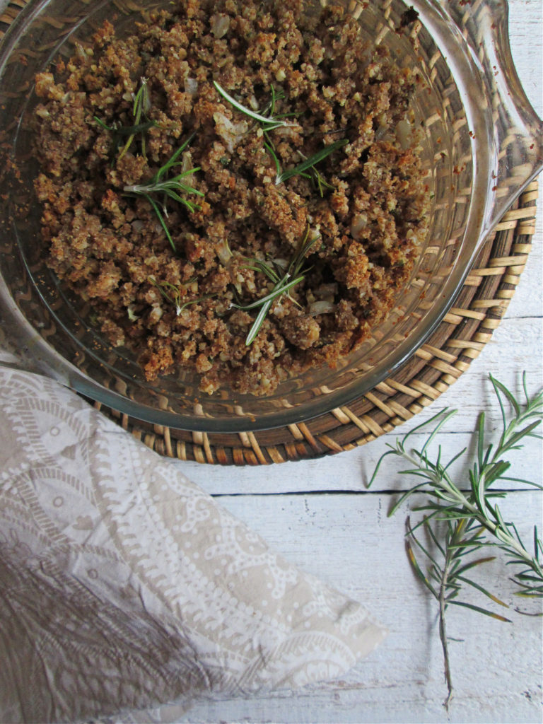 Rosemary and Walnut Stuffing in a bowl with rosemary sprigs