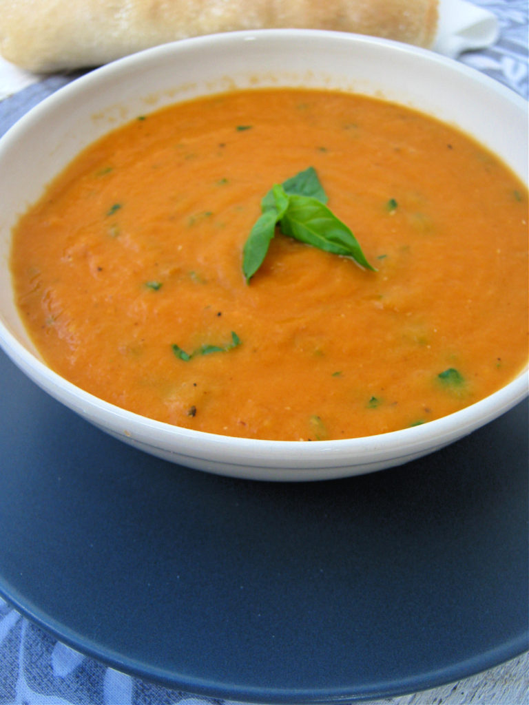 tomato and basil soup in a white bowl 
