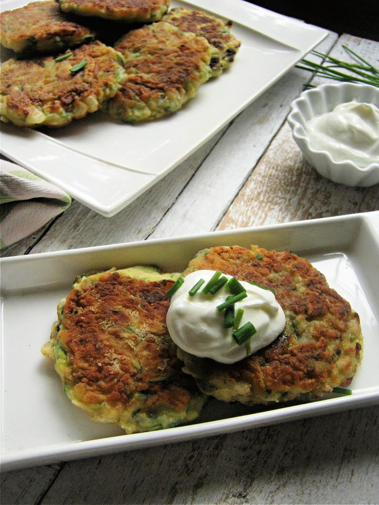 Zucchini Fritters on a plate with Greek Yogurt and chives