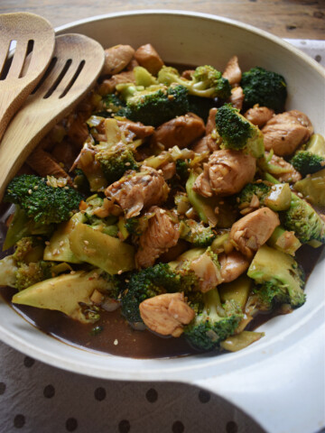 close up of the chicken and brtoccoli stir fry in a white skillet