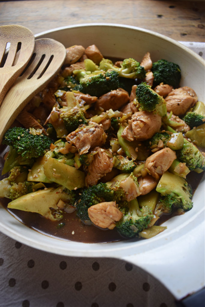close up of the chicken and brtoccoli stir fry in a white skillet