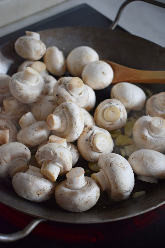 white button mushrooms in a skillet