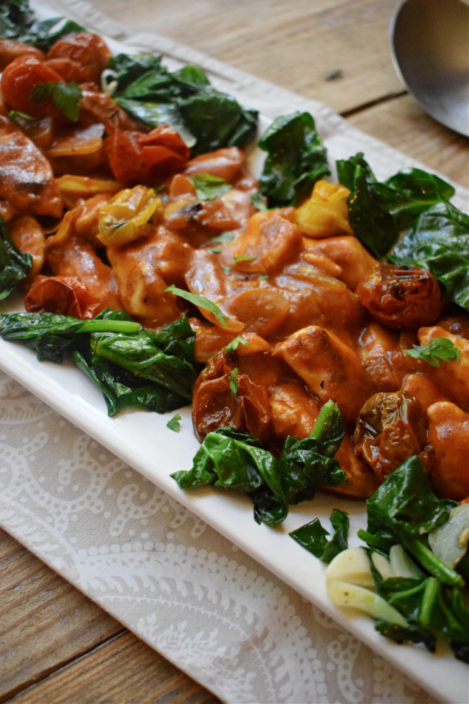 close up of the hot paprika chicken with sauteed spinach