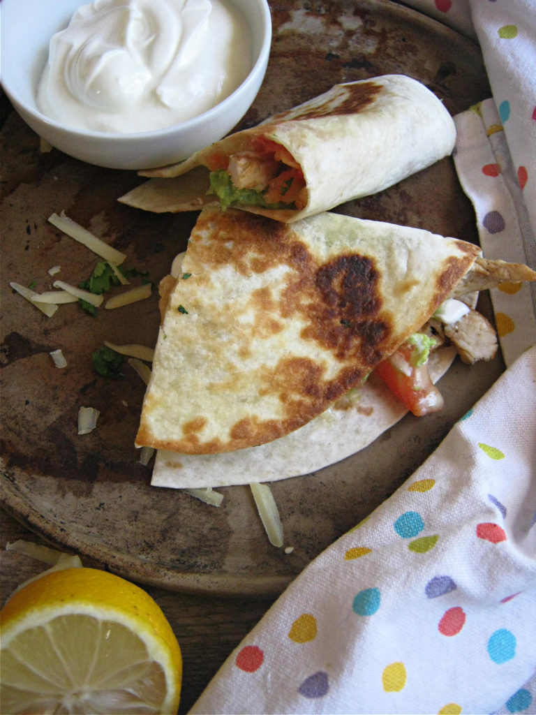 Chicken Quesadillas on a plate with sour cream