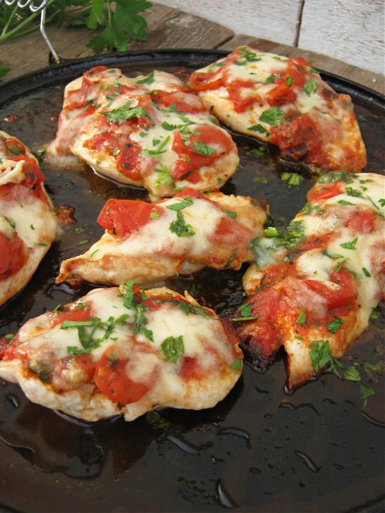 the Tomato and mozzarella skillet chicken on a cast iron dish