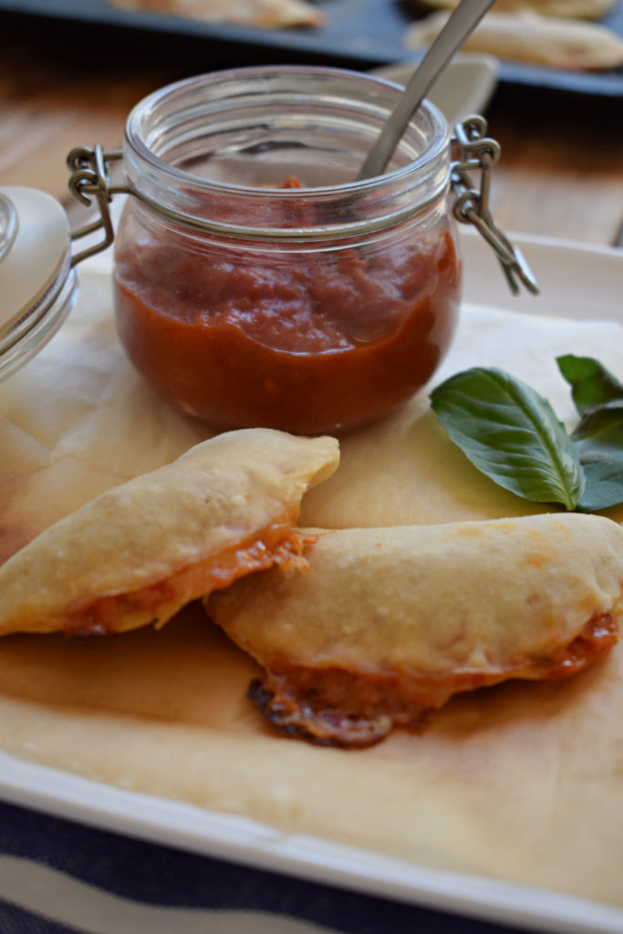 Pizza Pocket Bites with a jar of pizza sauce