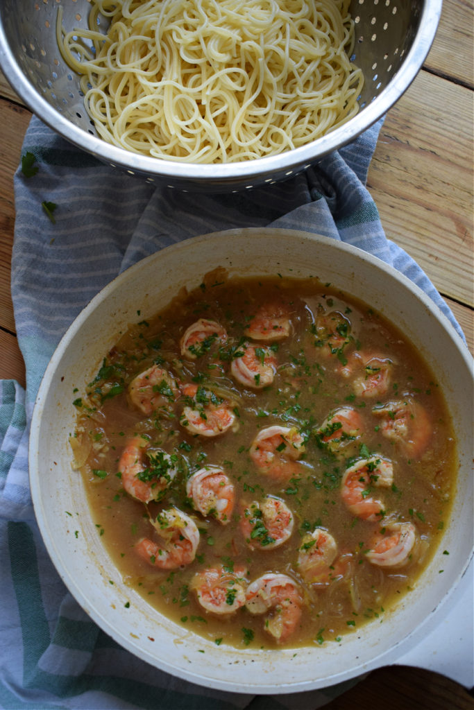 Cooked shrimp in a white wine sauce and linguine
