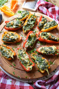 the feta and spinach peppers on a wooden tray