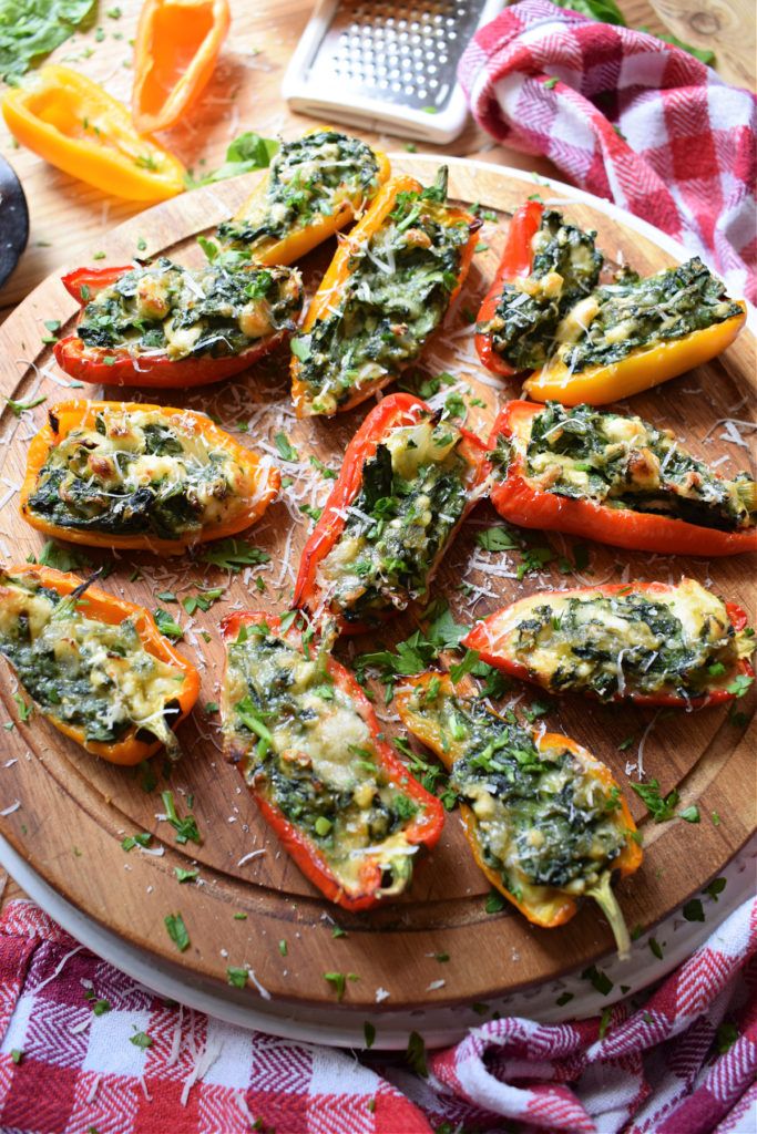 the feta and spinach peppers on a wooden tray