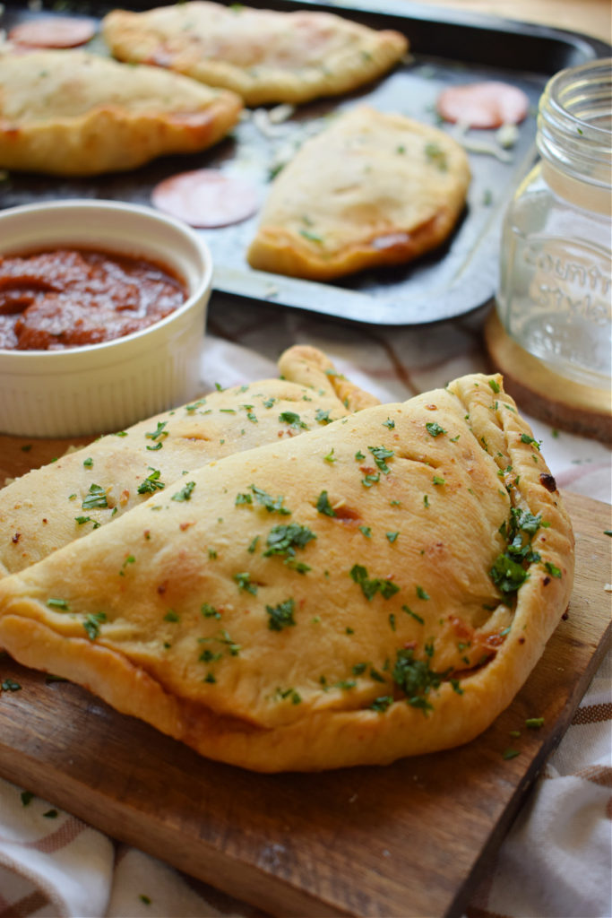 pepperoni calzones on a board