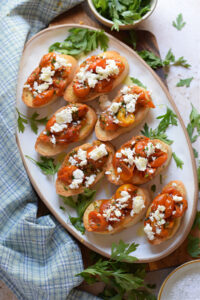 Tomato feta bruscehtta on a white tray.