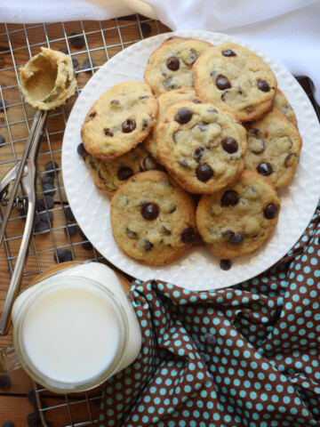 over head view of chocolate chip cookies and a glass of milk