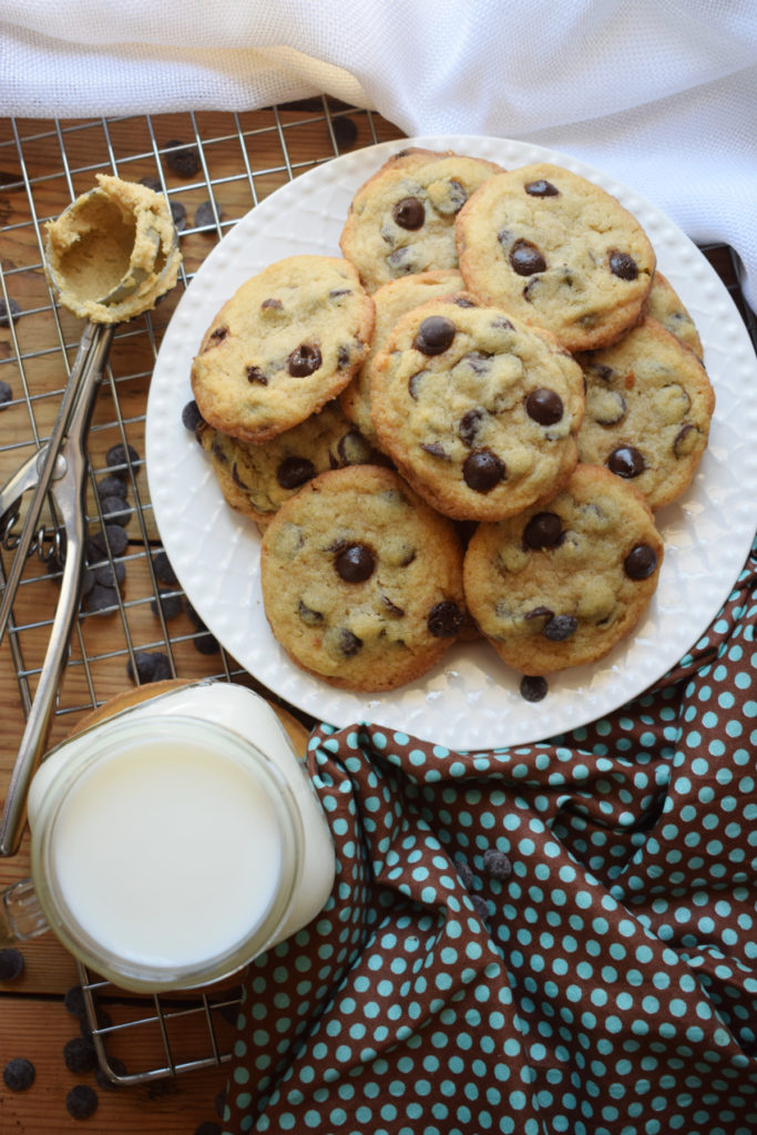 over head view of chocolate chip cookies and a glass of milk