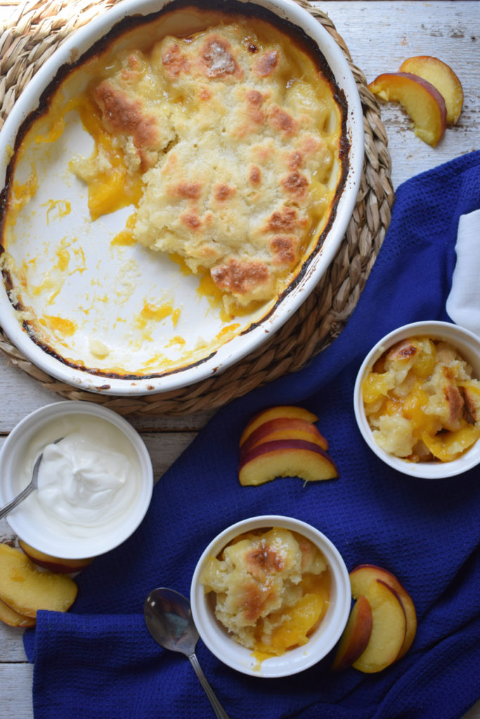 over head table setting view of the homemde peach cobbler