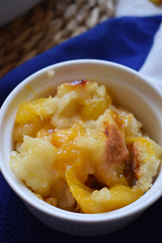 close up of peach cobbler in a small white dish