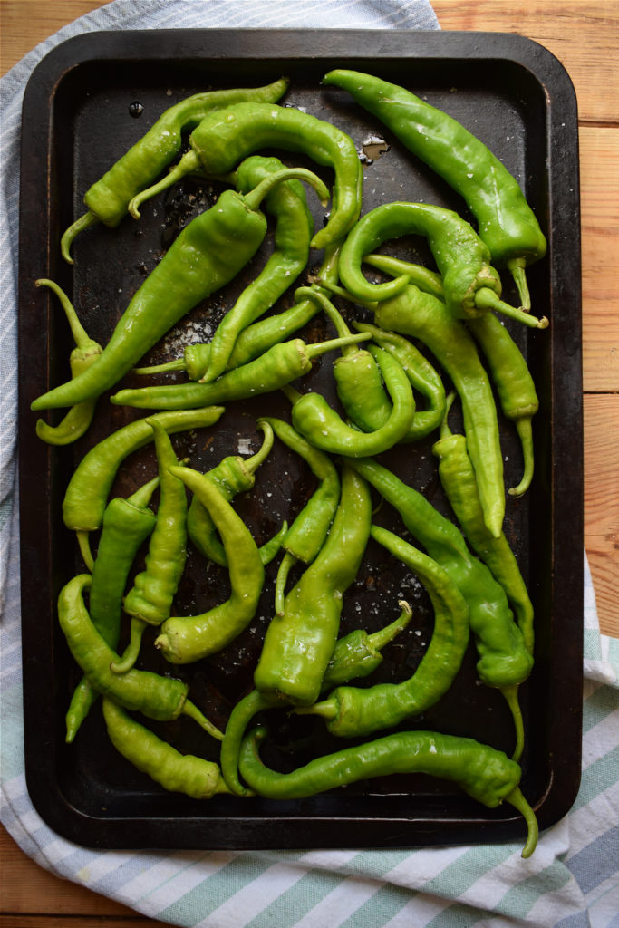 green peppers on a baking tray ready to roast.