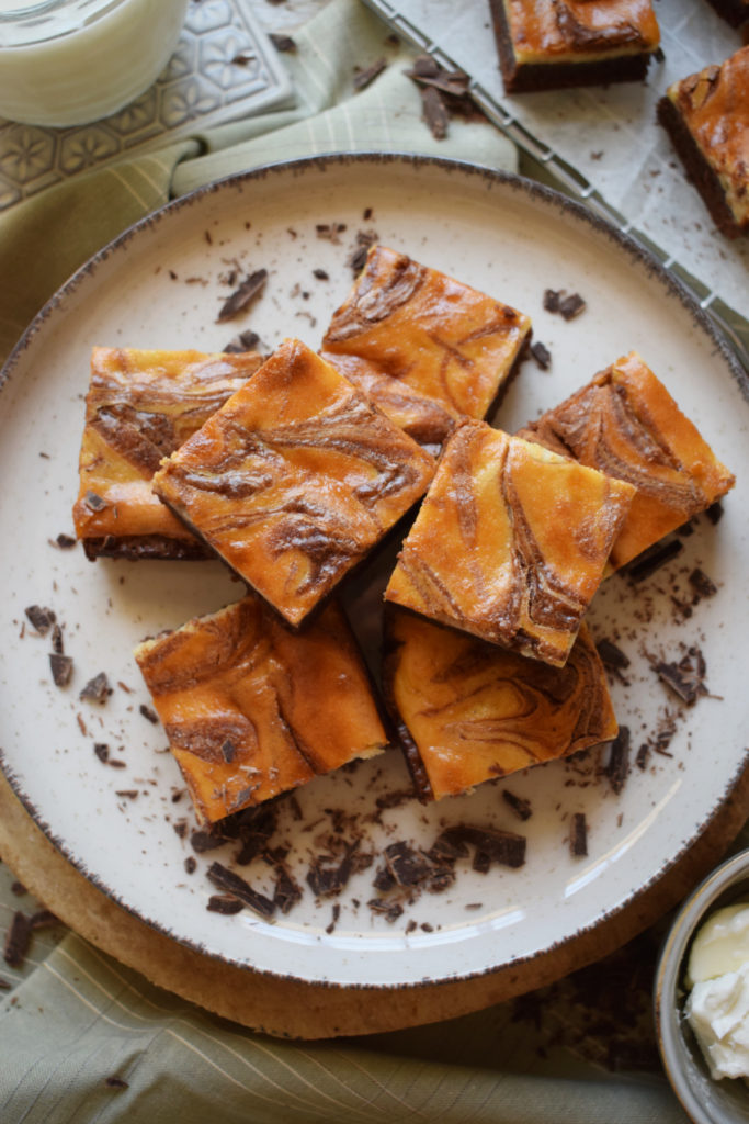 over head view of the cream cheese brownies on a white plate