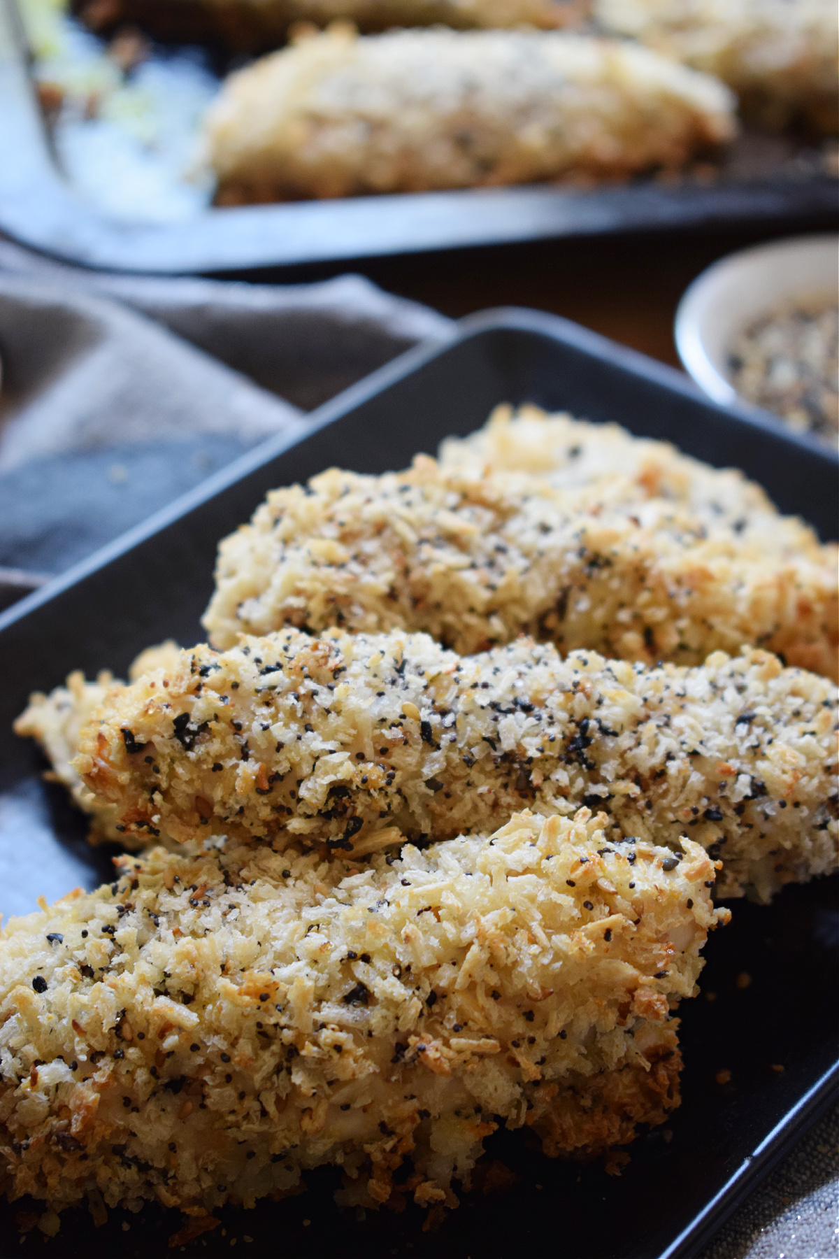 Everything Bagel Chicken Tenders on a black plate