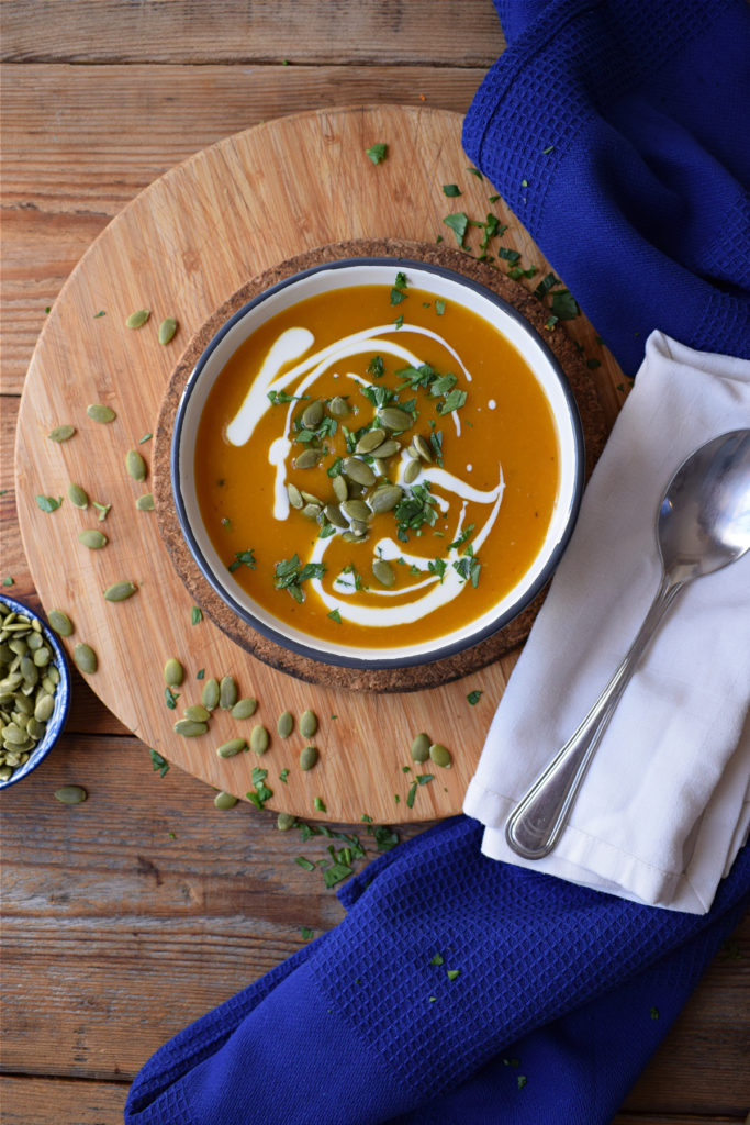 roasted butternut squash soup in a bowl with napkins