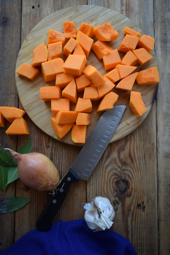cutting up squash to make the Spiced Roasted Butternut Squash Soup