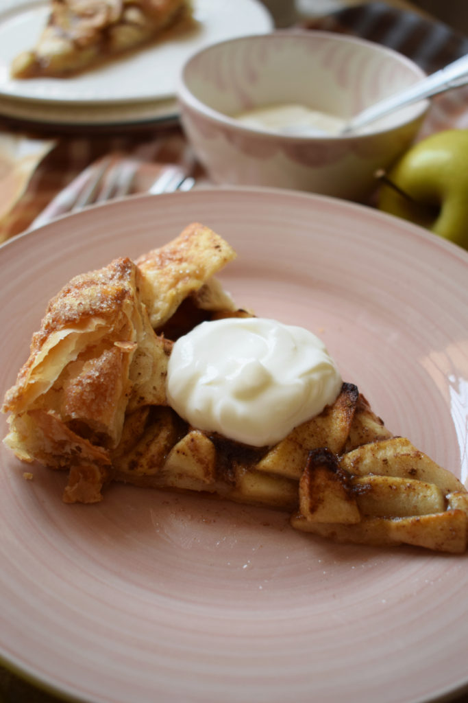 Puff pastry apple gallette on a pink plate