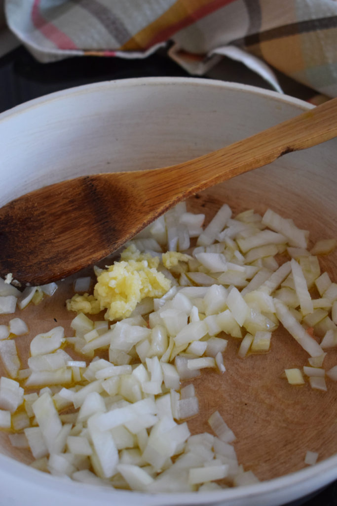 adding onions and garlic to the pan to cook for the easy teriyaki shrimp dish