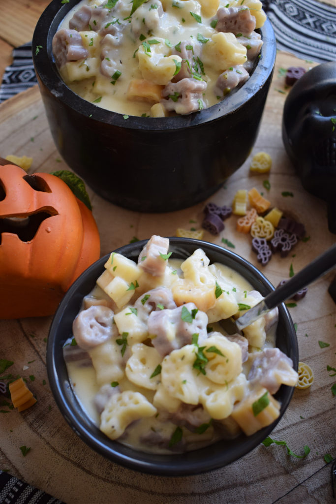 halloween macaroni and cheese in black bowls with pumpkins