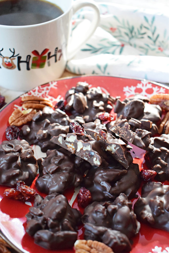 chocolate pecan cranberry clusters on a christmas plate