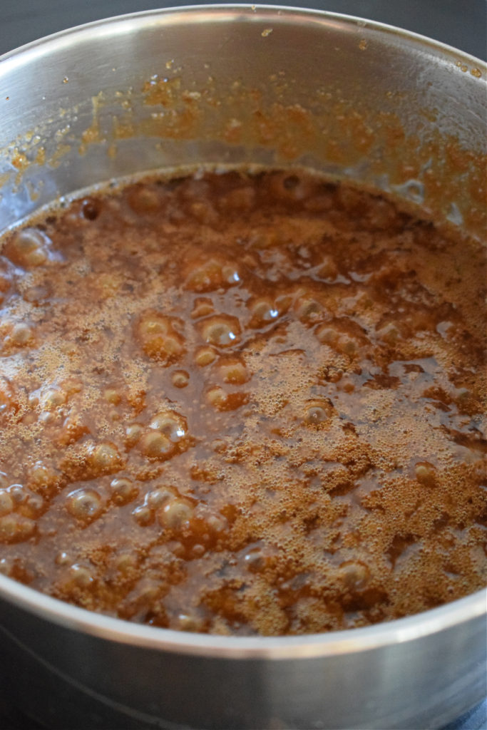 Boiling caramel in a saucepan.