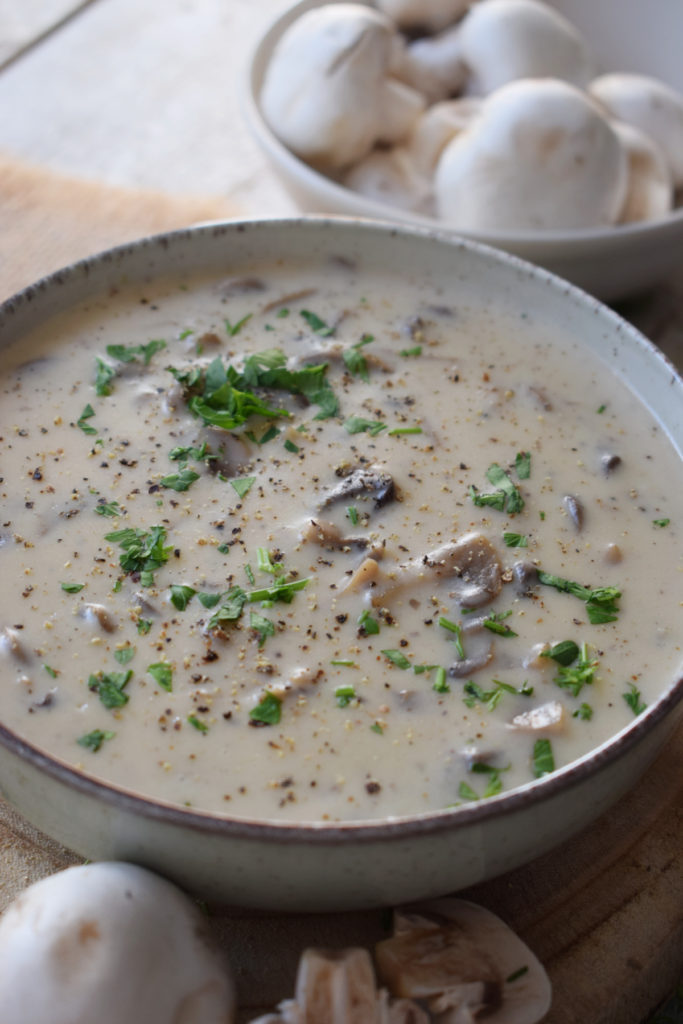 creamy mushroom sauce in a bowl with parsley and mushrooms