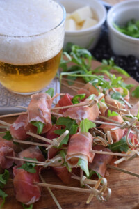 spanish ham and cured cheese bites with a glass of beer