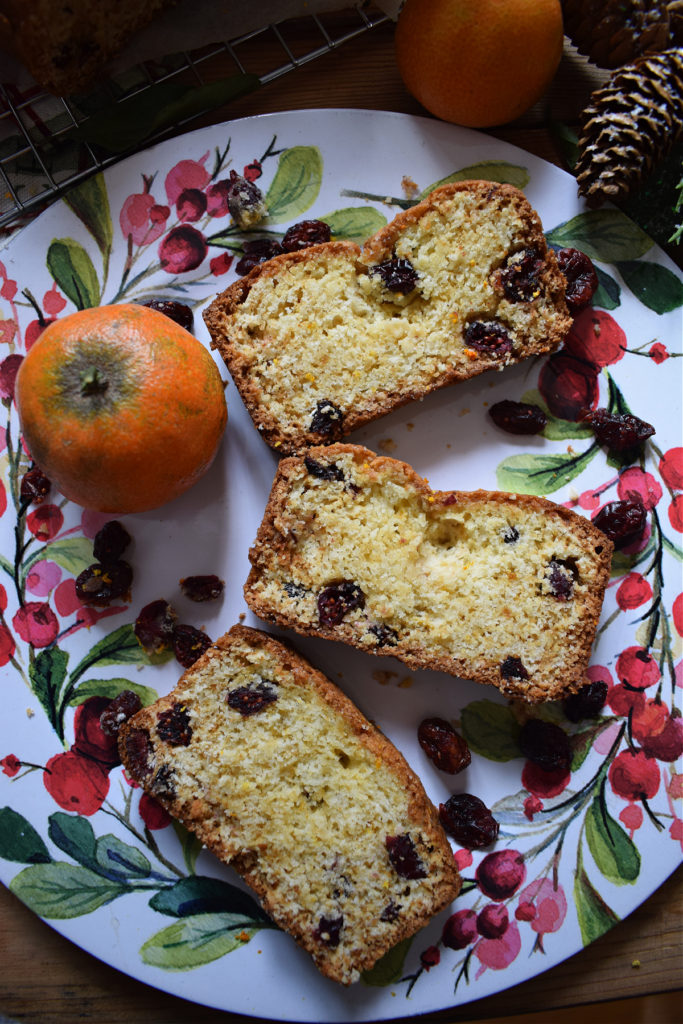 slices of cranberry orange loaf cake on a Christmas plate